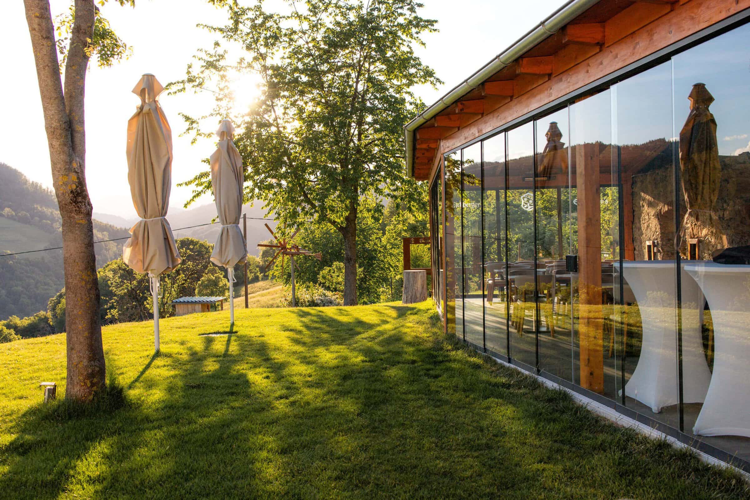 Großer Garten mit Sonnenlicht, Glasfassade Eichberger Grill-Events.